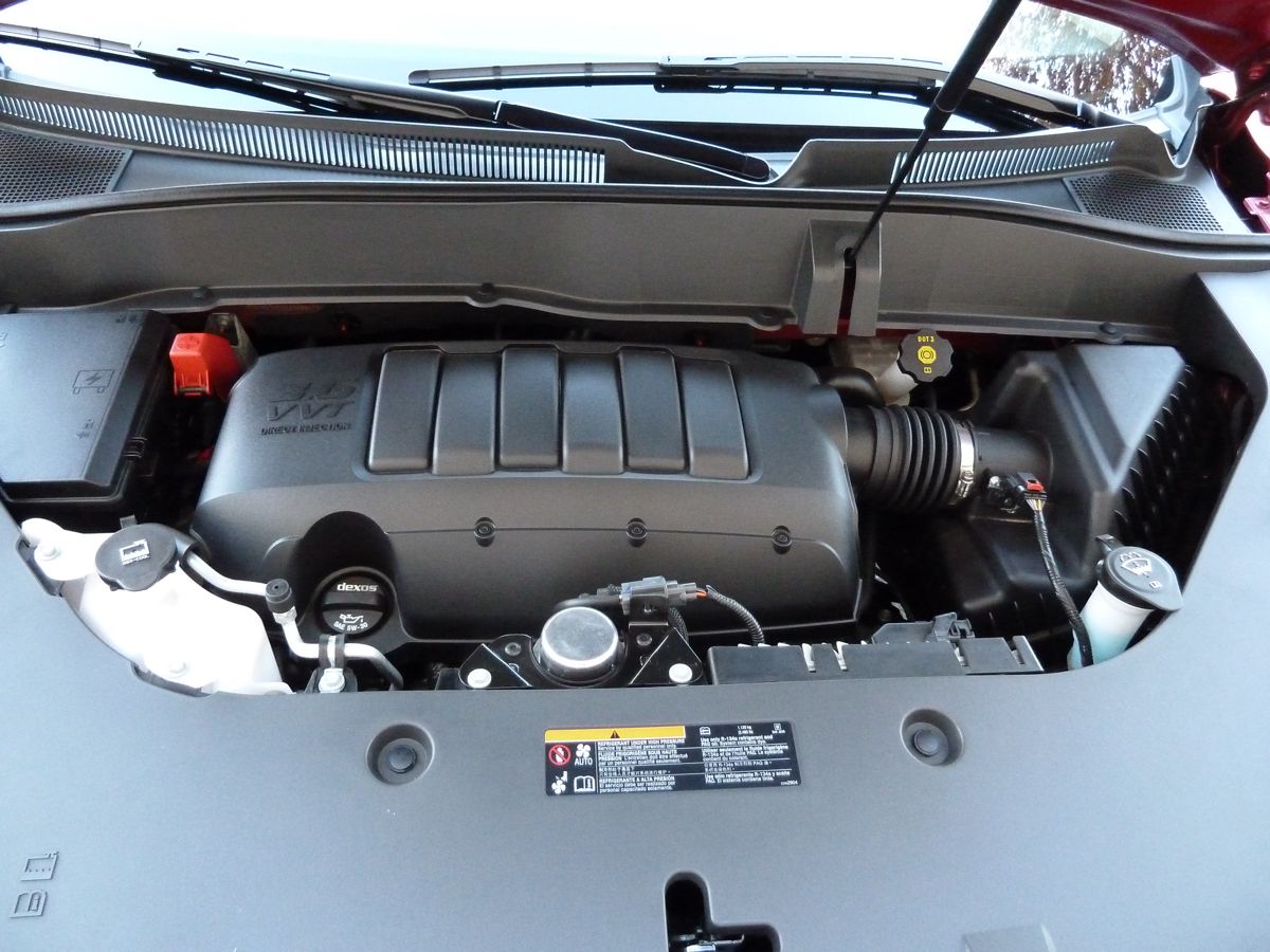 Believe it or not, the GMC really has an engine, and a fine one, underneath all that plastic shrouding