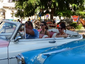 The perfect Tour Taxi scene -- two lovely young touristas out for a top down tour of Havana in a great American ragtop.